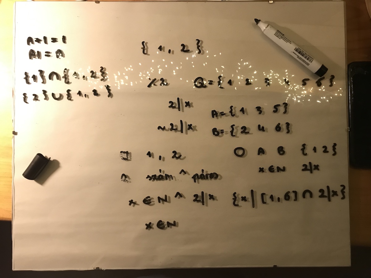 Marker pen notation on glass board for event algebra